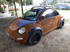 an old wooden car is parked in the dirt