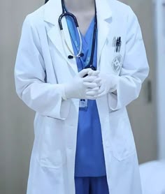 a woman wearing a white lab coat and holding a stethoscope