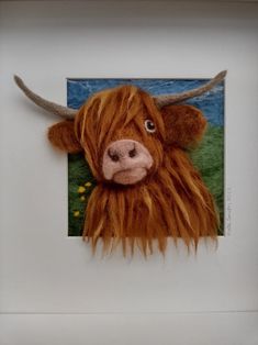 an animal with long hair is in a white frame