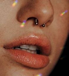 a woman with piercings on her nose