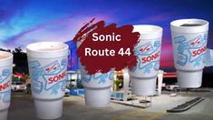 sonic route 4 cups are lined up in front of a gas station with the words sonic route 4 written on them