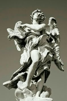 an angel statue is shown in black and white