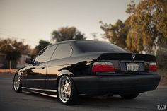 a black car is parked on the street