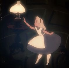alice from the disney movie is holding a lamp in her hand and pointing at it