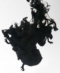 black and white photograph of a skateboarder doing a trick in the air with his board