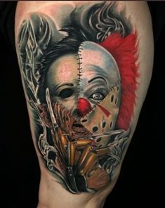 a tattoo with a clown mask on it's leg and a knife in its mouth