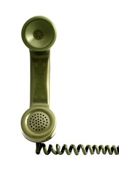 an old fashioned green phone is laying on its side next to a spirally cord