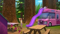 a pink bus parked next to a picnic table with a slide in front of it