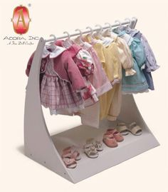 a display rack with clothes and shoes on it for children's clothing or baby's accessories