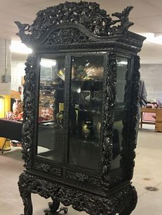 an ornate display case in the middle of a room