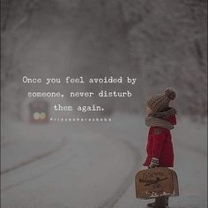 a person standing in the snow holding a suitcase with a quote on it that says, once you feel avoided by someone, never disturb them again