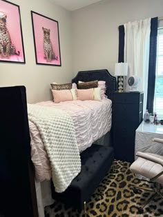 the bedroom is decorated in pink, black and white with cheetah prints on the wall