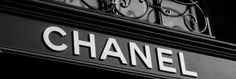 black and white photograph of the entrance to a chanel store in paris, france