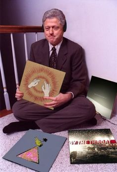 a man sitting on the floor with some books