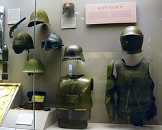 helmets and armor are on display in a museum