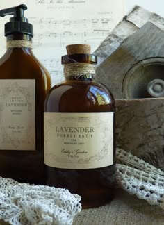 two bottles of soap sitting on top of a table