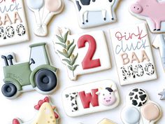 decorated cookies with farm animals, tractor and numbers on top of each cookie are shown
