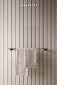 two white towels hanging on a towel rack