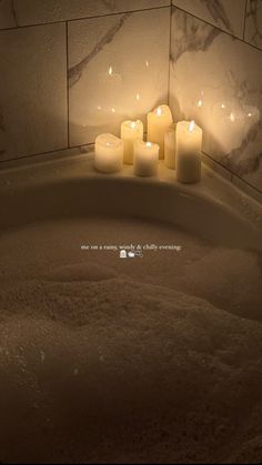 candles are sitting in the middle of a bathtub