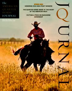 a man riding on the back of a black horse in a dry grass covered field