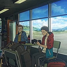 two people sitting at a table with luggage in front of them, looking out the window