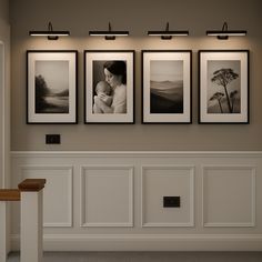 three framed photographs hang on the wall above a staircase