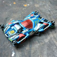 a toy car is laying on the ground
