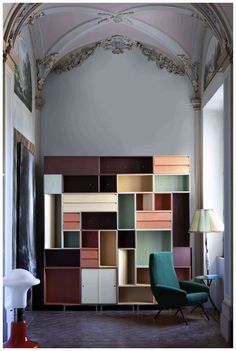 the room has many different colored shelves in it