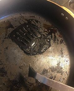 a frying pan with some food cooking in it and a spatula on the side