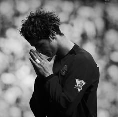 a man holding his hands to his face