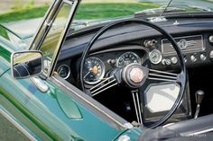 the interior of an old green car with gauges and dash lights on it's dashboard
