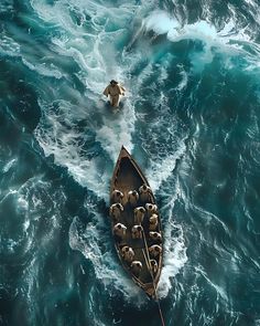 an aerial view of a boat in the ocean with sheep on it's side
