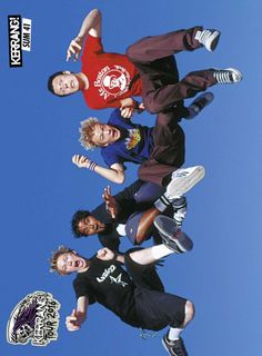 four young men standing in the air with their skateboards