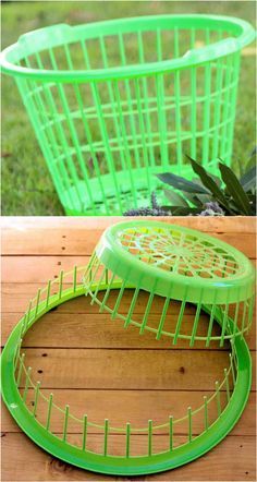 two green plastic baskets sitting on top of a wooden table next to plants and grass