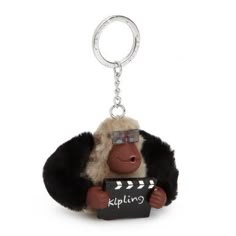 a keychain with a monkey holding a sign that says klipling on it