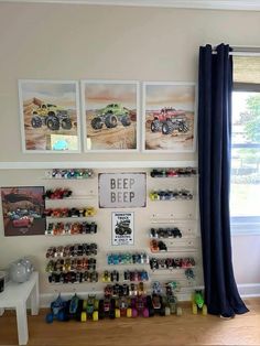 a room filled with lots of toys and pictures on the wall next to a window