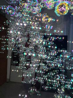 bubbles floating in the air near a window