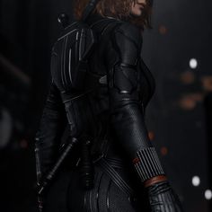 a woman dressed as black widow standing in the dark