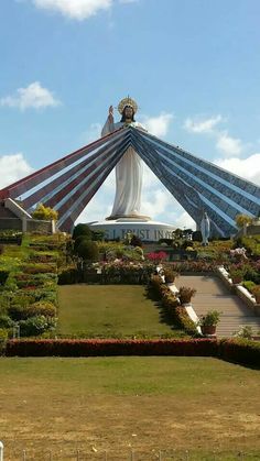 a large statue in the middle of a garden