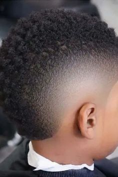 Discover the trendiest black boy haircuts for kids! From classic fades to stylish afros, we've got the perfect hairstyles to make your little one look dapper. Browse our collection of cool and versatile cuts that are sure to suit any personality. Whether you prefer a low maintenance buzz cut or edgy designs, these hairstyles will keep your kid looking sharp and confident. Get inspired and find the perfect black boy haircut that will make heads turn wherever he goes! Toddler Afro Haircut, Boys Afro Fade, Burst Fade Mohawk Kids, Haircut Black Boys, Kids Burst Fade Mohawk, Little Boy Haircut Black, Frohawk Fade Boys, Baby Afro Haircut, Haircuts For Toddler Boys With Curls