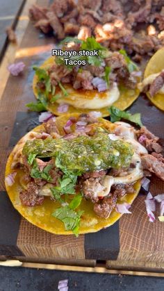three tacos are sitting on a cutting board