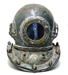 an old diving helmet is shown against a white background with the reflection of another object in it