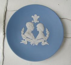 a blue and white plate with two people on it