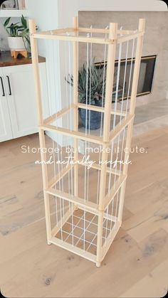 a wooden shelf with three shelves on top of it in the middle of a room