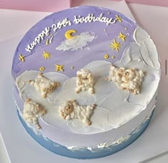 a birthday cake decorated with sheep and stars