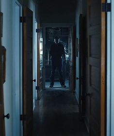 a man standing in the doorway of a building