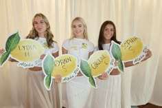 three young women holding up signs that say yola and kyon are lemons