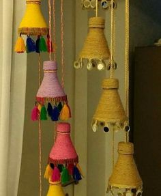 a bunch of colorful bells hanging from a ceiling