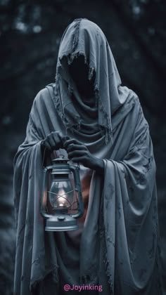 a person in a hooded cloak holding a lantern