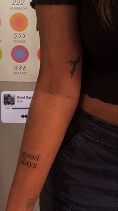 a woman's arm with tattoos on it that says good days and an arrow